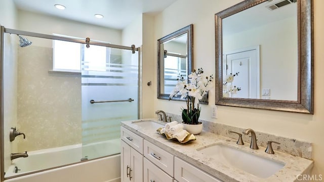 bathroom featuring enclosed tub / shower combo and vanity