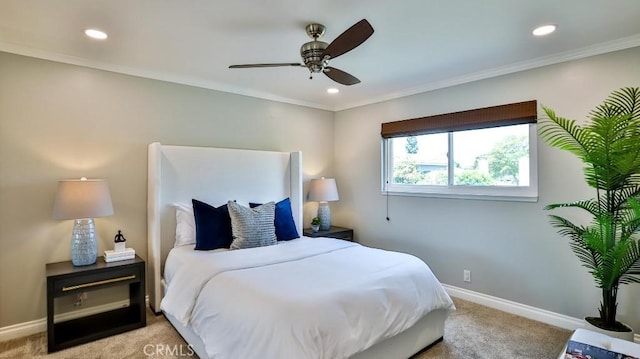 bedroom with light colored carpet, ceiling fan, and crown molding