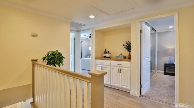 hall featuring crown molding and light hardwood / wood-style flooring