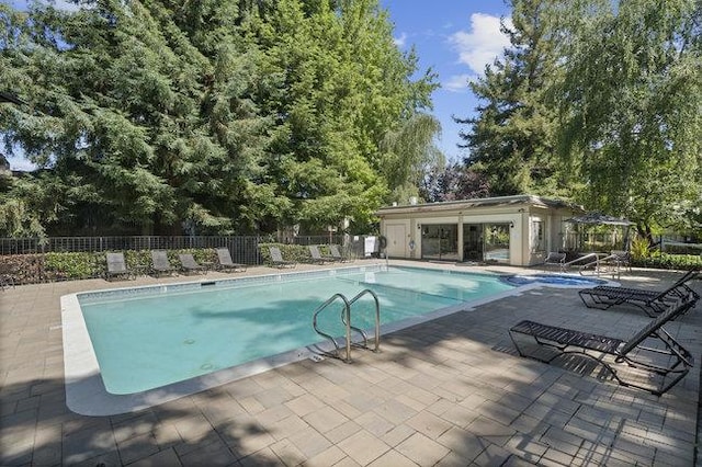 view of swimming pool featuring a patio area