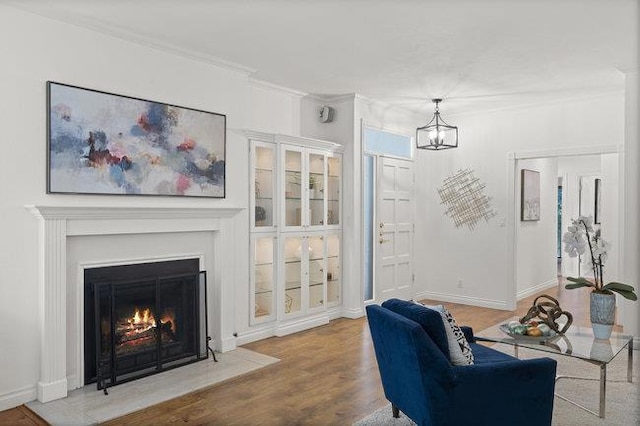 living room with wood-type flooring and crown molding