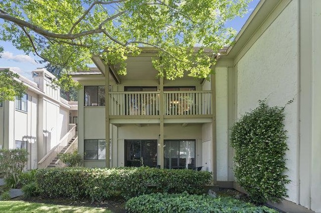 back of property featuring a balcony