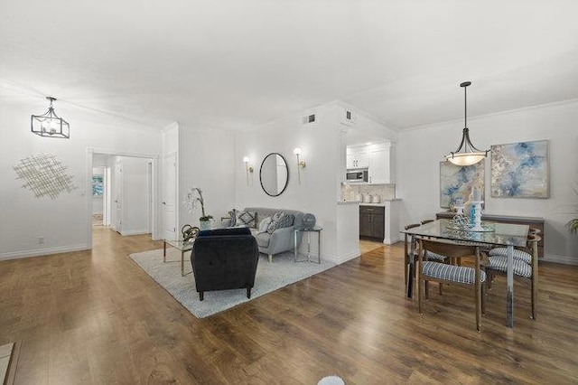 living room featuring hardwood / wood-style floors and crown molding