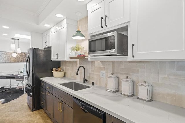 kitchen with white cabinets, hanging light fixtures, and dishwashing machine