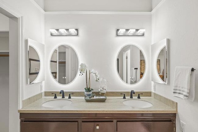 bathroom with crown molding and vanity