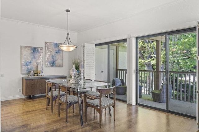 dining room with dark hardwood / wood-style floors, expansive windows, and ornamental molding