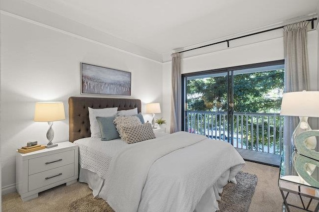 bedroom with light colored carpet, multiple windows, crown molding, and access to outside