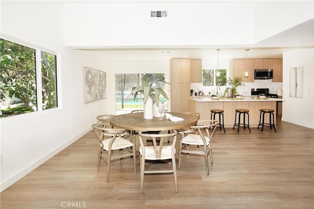 dining space with light wood-type flooring