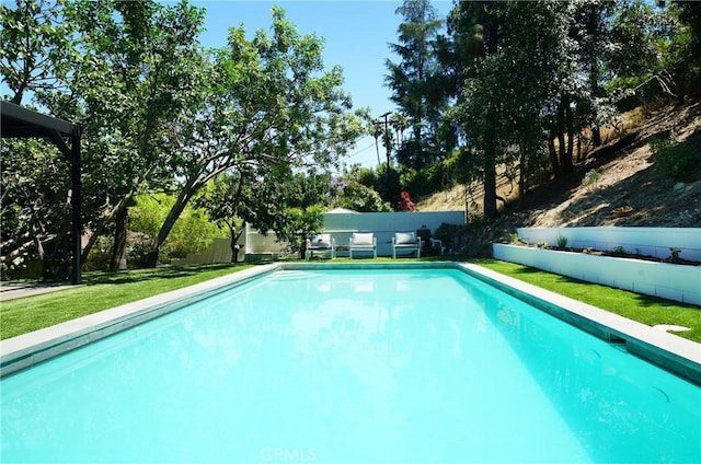 view of pool featuring a yard