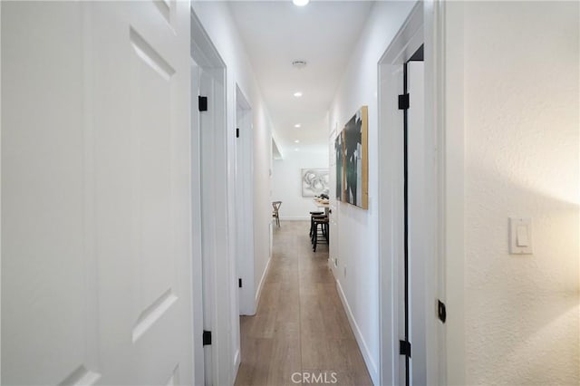 corridor featuring light hardwood / wood-style floors