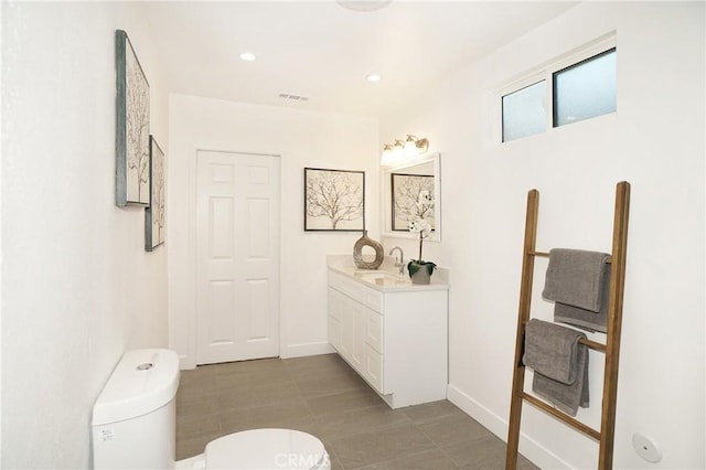 bathroom featuring tile patterned floors, vanity, and toilet