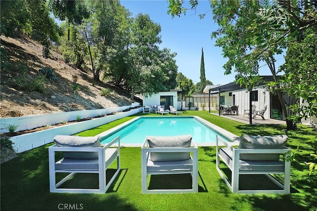 view of swimming pool with a patio, a yard, an outdoor hangout area, and an outdoor structure