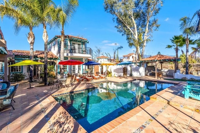 view of swimming pool featuring a patio area and a gazebo