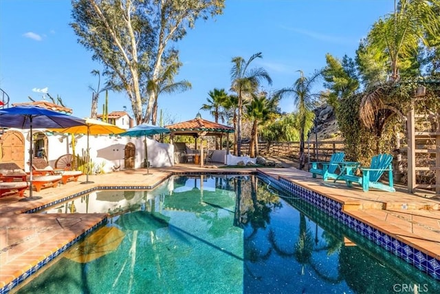 view of swimming pool featuring a patio and a gazebo