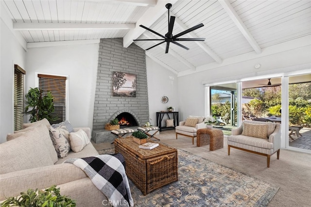 carpeted living room featuring ceiling fan, beamed ceiling, high vaulted ceiling, and a fireplace