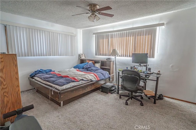 carpeted bedroom featuring a textured ceiling and ceiling fan