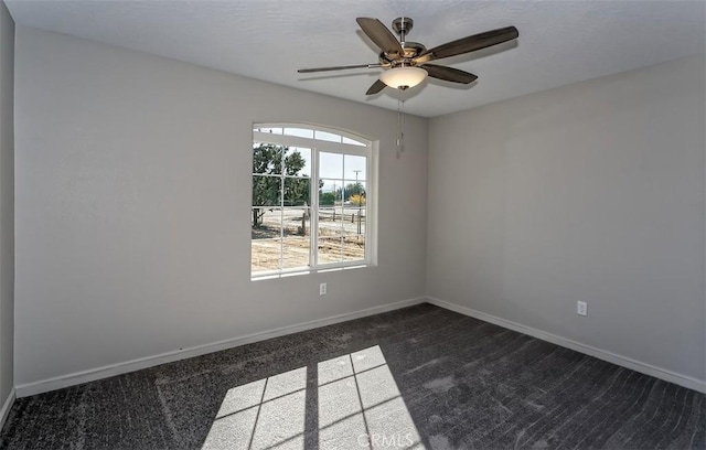 carpeted empty room featuring ceiling fan