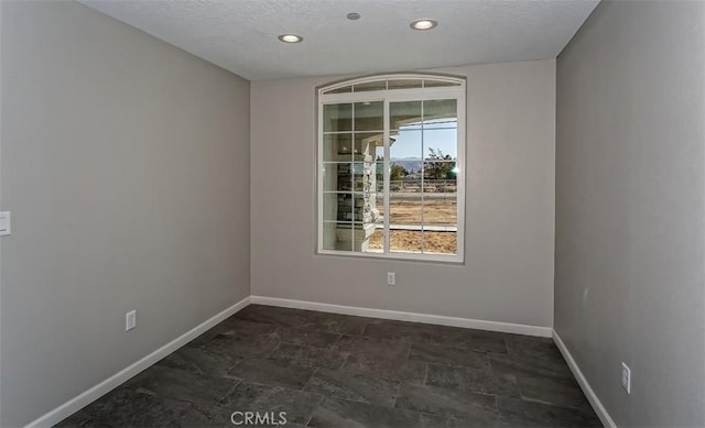 empty room featuring a textured ceiling