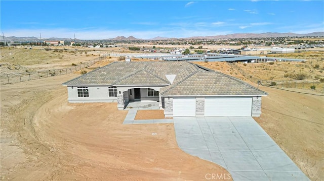 ranch-style home with a garage and a mountain view