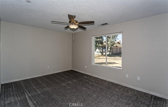 carpeted spare room with a textured ceiling and ceiling fan