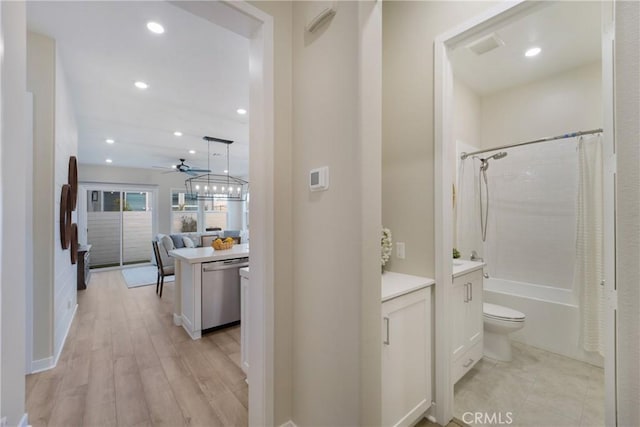 corridor with light hardwood / wood-style floors