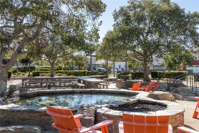 view of pool featuring a patio and a fire pit