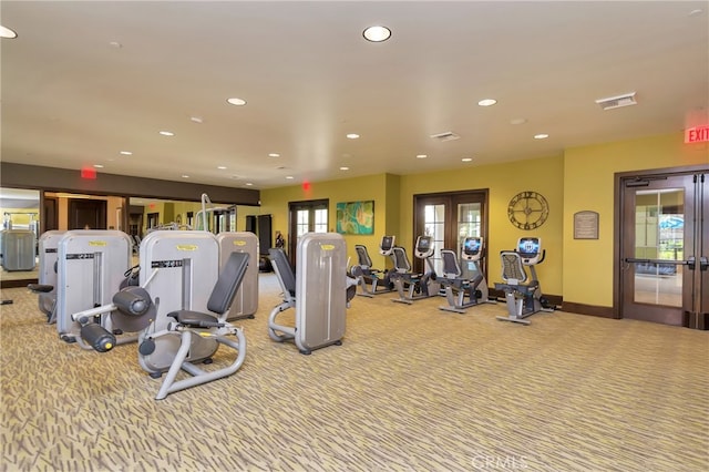 exercise room featuring light colored carpet and french doors