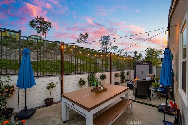 patio terrace at dusk with a fire pit