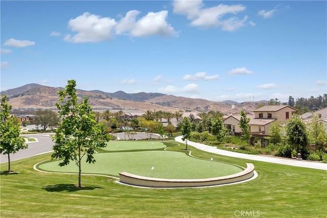 surrounding community featuring a mountain view and a lawn