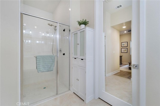 bathroom featuring a shower with shower door