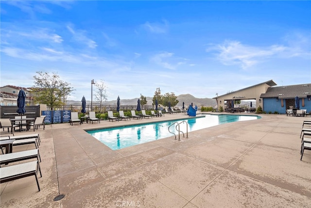 view of pool with a mountain view and a patio area