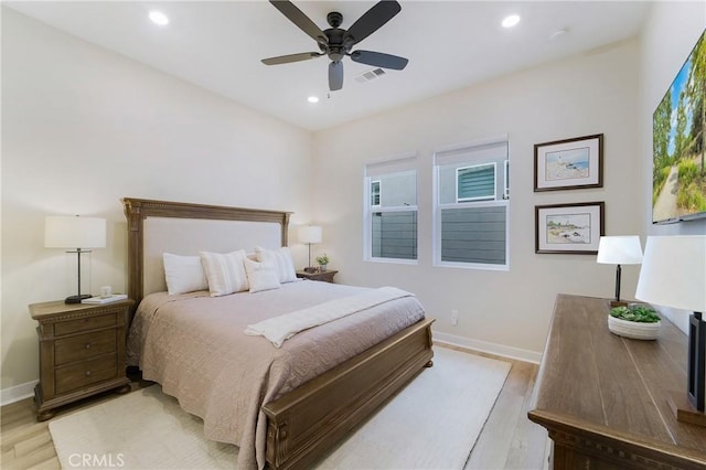 bedroom with ceiling fan and light hardwood / wood-style flooring