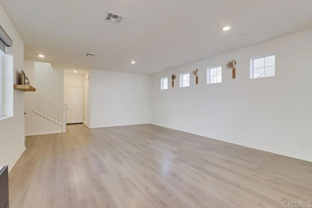 basement with light hardwood / wood-style flooring