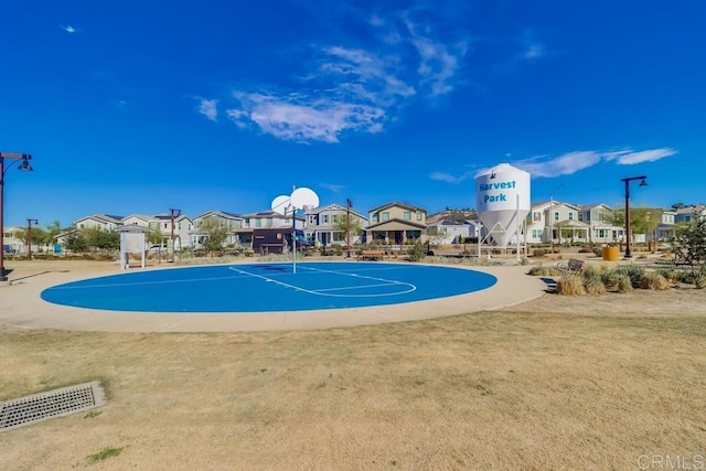 view of pool with basketball court and a lawn