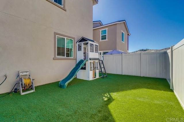 view of jungle gym with a lawn