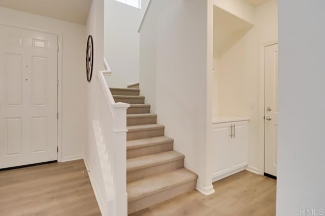 staircase with hardwood / wood-style floors