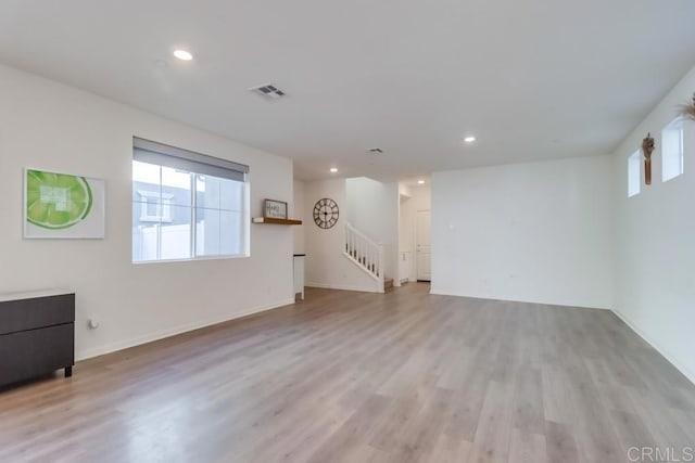 unfurnished living room with light hardwood / wood-style flooring