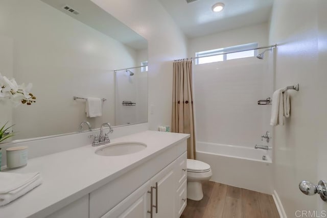 full bathroom featuring toilet, shower / tub combo, vanity, and hardwood / wood-style floors