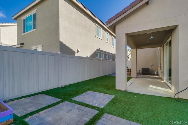 view of yard featuring a patio and central AC