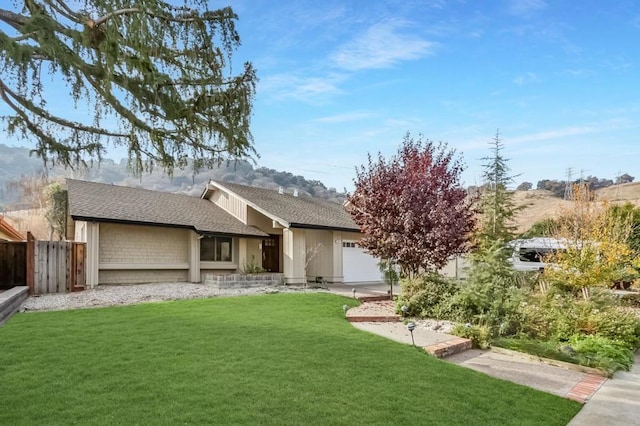 view of front of house featuring a front yard and a garage