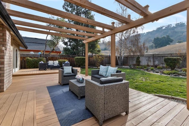 deck featuring an outdoor hangout area, a pergola, a lawn, and a mountain view