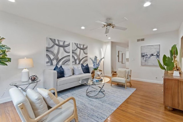 living room with hardwood / wood-style flooring and ceiling fan