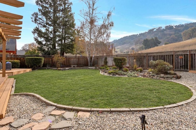 view of yard featuring a deck with mountain view