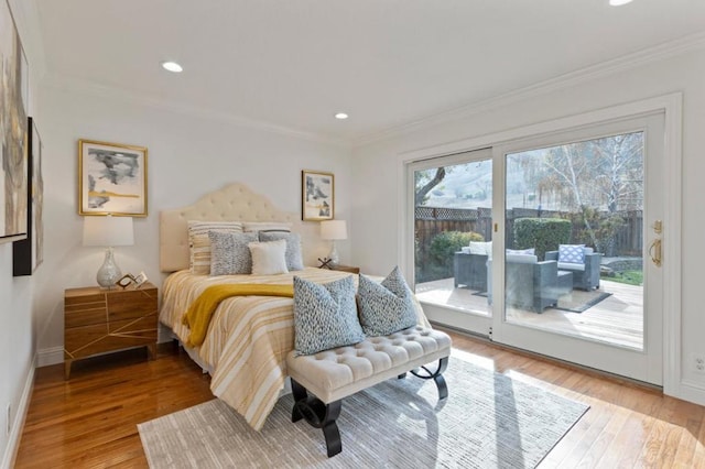 bedroom with ornamental molding, hardwood / wood-style floors, and access to outside