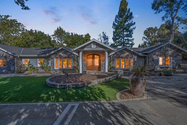 ranch-style home with a lawn