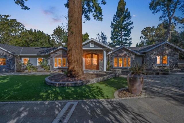 ranch-style home with a lawn