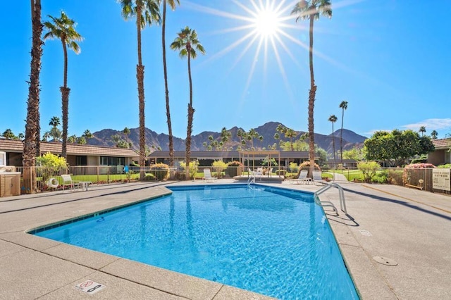 view of pool with a patio area and a mountain view