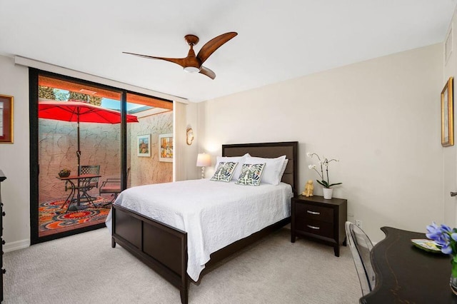 bedroom with a wall of windows, ceiling fan, access to outside, and light colored carpet