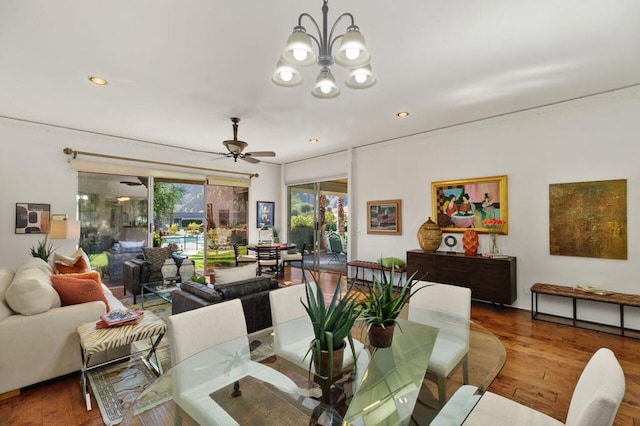 dining space featuring ceiling fan with notable chandelier and hardwood / wood-style floors