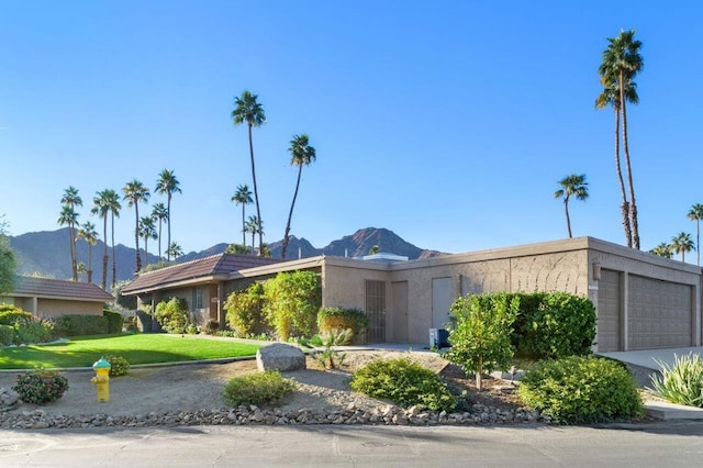 view of front of home featuring a mountain view and a garage